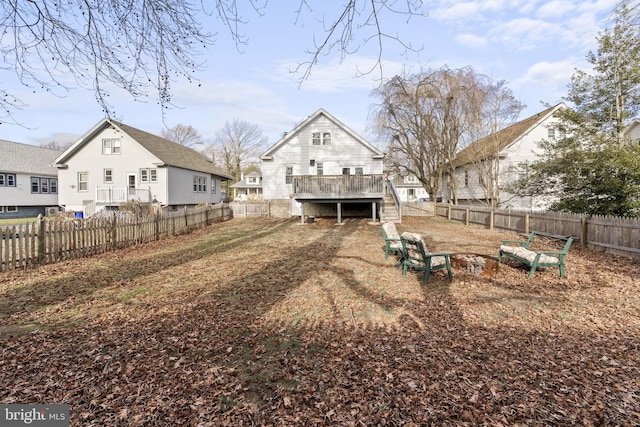 back of property featuring a fenced backyard, stairway, and a wooden deck