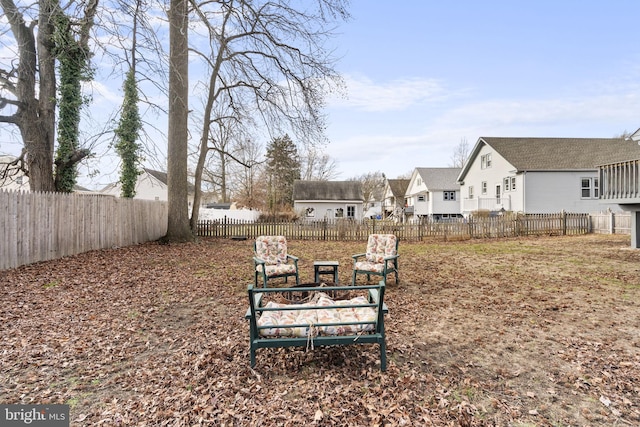 view of yard featuring a fenced backyard and a residential view