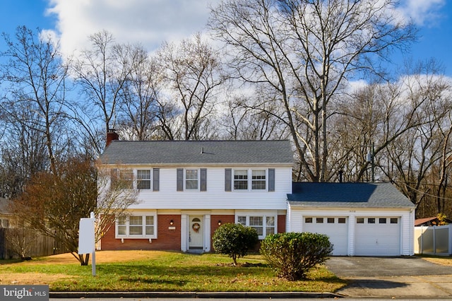 view of front facade with a front yard and a garage