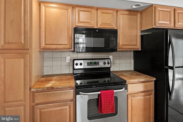 kitchen with wood counters, tasteful backsplash, and black appliances