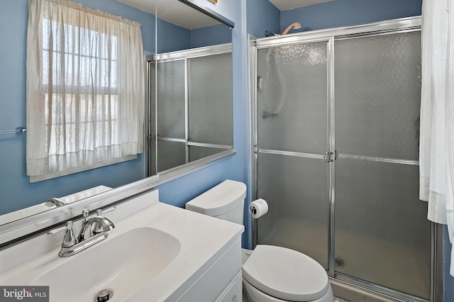 bathroom with vanity, toilet, and walk in shower