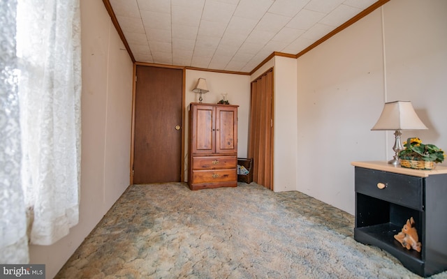 unfurnished bedroom featuring carpet and crown molding