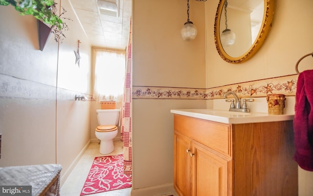 bathroom featuring vanity, toilet, and tile patterned floors