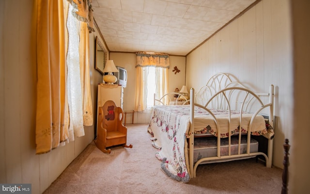 bedroom with carpet floors and crown molding