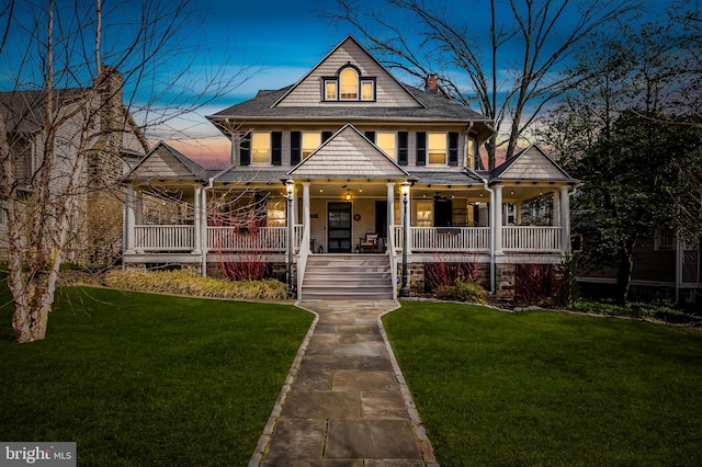 view of front of house with a porch and a front yard