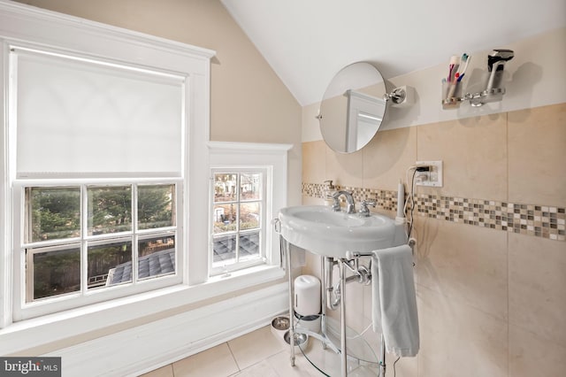 bathroom with tile patterned flooring and vaulted ceiling