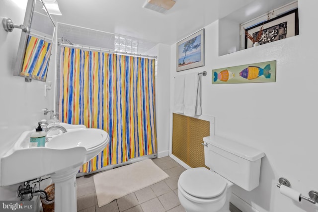 bathroom with toilet, tile patterned flooring, and a shower with shower curtain