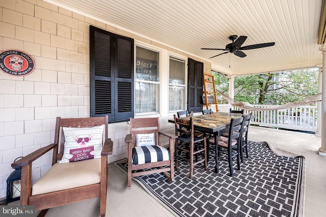 view of patio / terrace with covered porch, outdoor dining area, and a ceiling fan