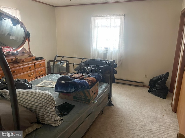 bedroom with a baseboard heating unit, ornamental molding, and carpet floors