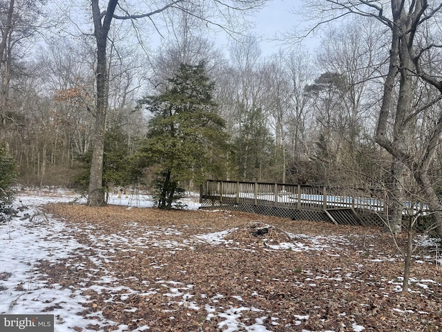 snowy yard with a deck