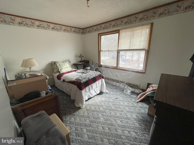 carpeted bedroom with ornamental molding and a textured ceiling