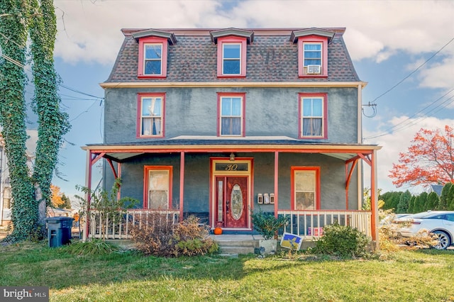 view of front of property with covered porch and a front lawn