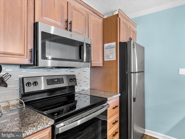 kitchen featuring crown molding, stainless steel appliances, light brown cabinets, a textured ceiling, and dark stone counters