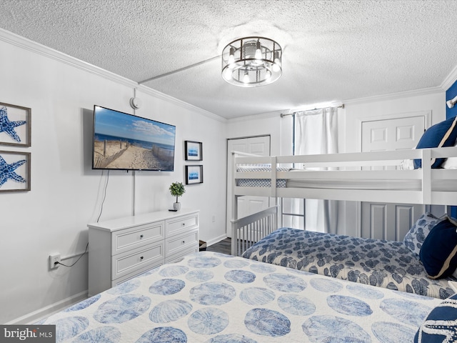 bedroom featuring crown molding, a textured ceiling, baseboards, and an inviting chandelier