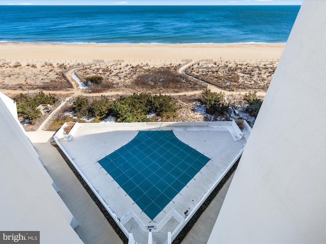 exterior space with a water view and a view of the beach