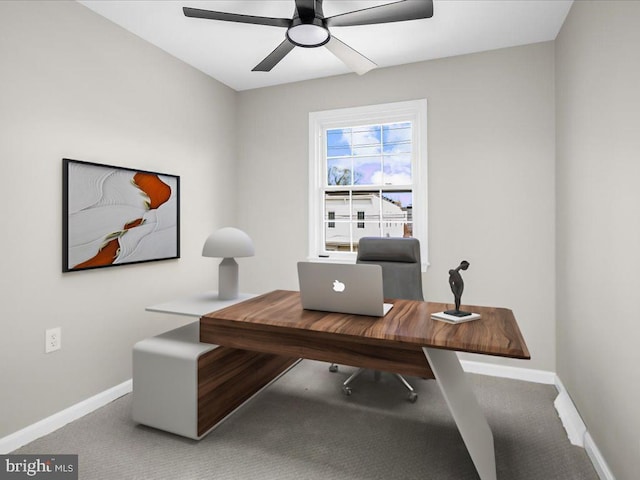 office space with a ceiling fan, carpet flooring, and baseboards