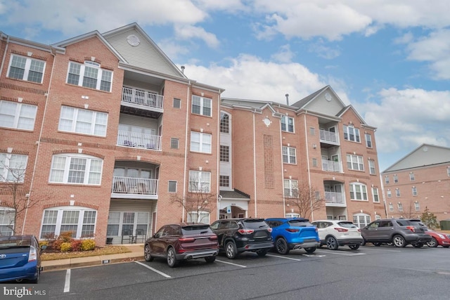 view of building exterior with uncovered parking