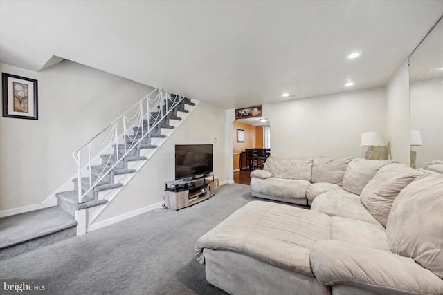 carpeted living area with baseboards, stairway, and recessed lighting