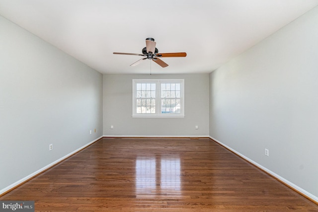 unfurnished room with ceiling fan, baseboards, and wood finished floors