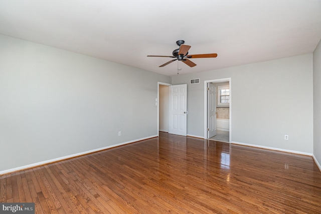 unfurnished bedroom with baseboards, visible vents, a ceiling fan, hardwood / wood-style floors, and ensuite bathroom