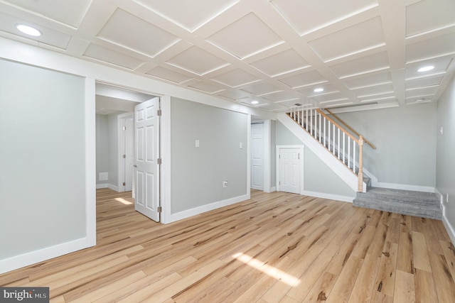 finished below grade area with light wood-type flooring, baseboards, stairway, and recessed lighting