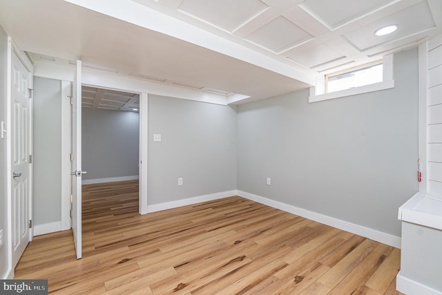 below grade area with light wood-type flooring and baseboards