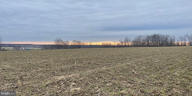 nature at dusk featuring a rural view