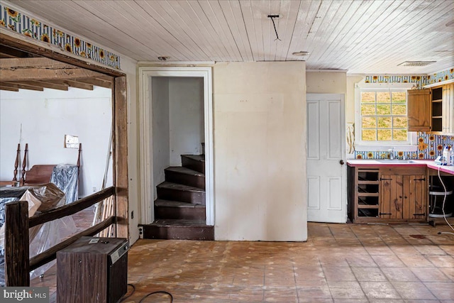 interior space featuring wood ceiling, stairs, and a sink