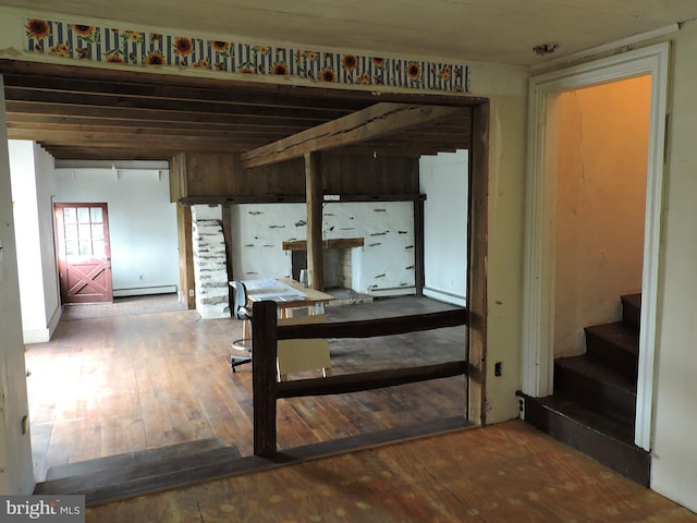 interior space featuring a baseboard radiator, wood-type flooring, and stairs