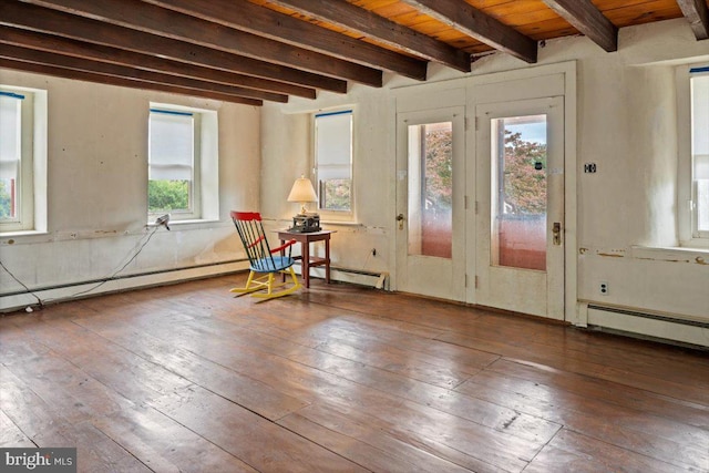 interior space with a baseboard radiator, wood-type flooring, and beamed ceiling