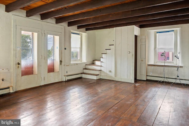 interior space featuring plenty of natural light, dark wood-type flooring, stairway, and a baseboard radiator