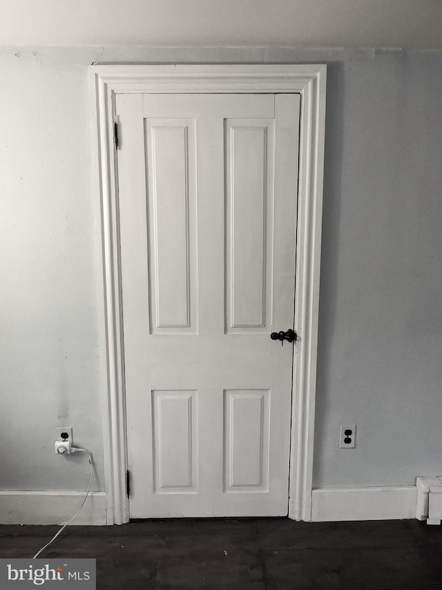 interior details featuring baseboards and wood finished floors