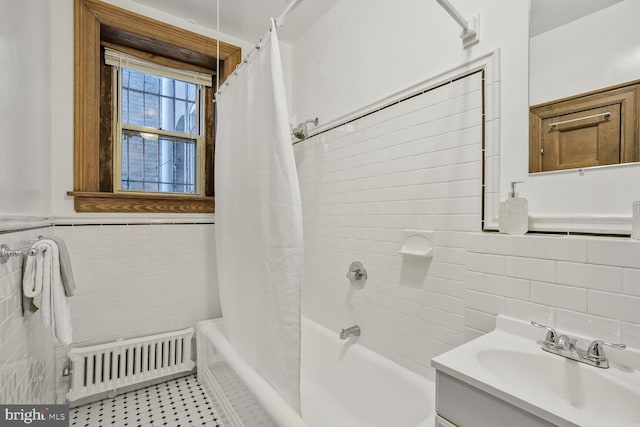 full bath with vanity, tile walls, tile patterned floors, radiator heating unit, and shower / bathtub combination with curtain