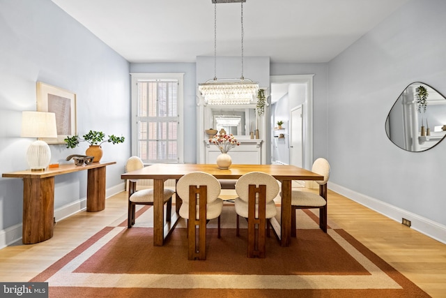 dining room with light wood-style floors and baseboards