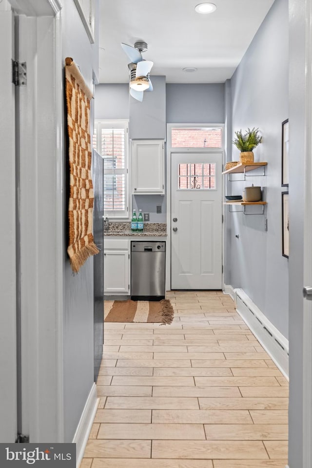 kitchen with dishwasher, open shelves, light wood-style flooring, and white cabinets