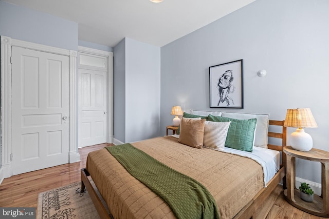 bedroom featuring wood finished floors and baseboards