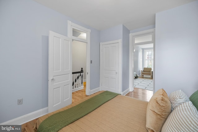 bedroom featuring light wood-type flooring and baseboards