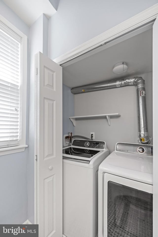 clothes washing area with laundry area and washing machine and clothes dryer