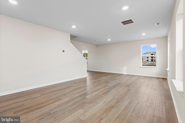 interior space featuring light wood-style flooring, recessed lighting, baseboards, and visible vents