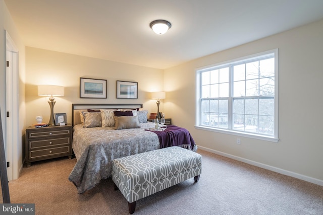 bedroom with multiple windows and light carpet