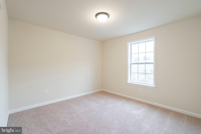 unfurnished room with light colored carpet