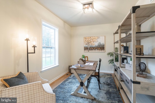 home office with hardwood / wood-style floors