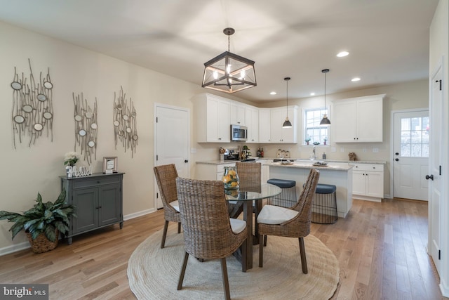 dining area featuring light hardwood / wood-style flooring and sink