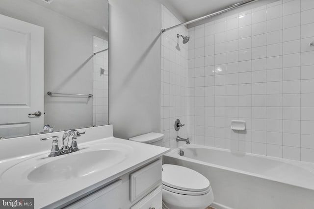 bathroom featuring toilet, bathing tub / shower combination, and vanity