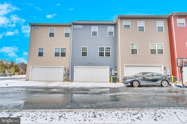 rear view of house with an attached garage