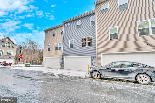 back of property featuring an attached garage