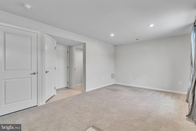 unfurnished bedroom with recessed lighting, light carpet, visible vents, and baseboards