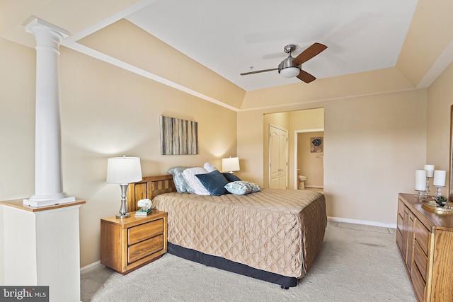 bedroom featuring decorative columns, baseboards, connected bathroom, and light colored carpet