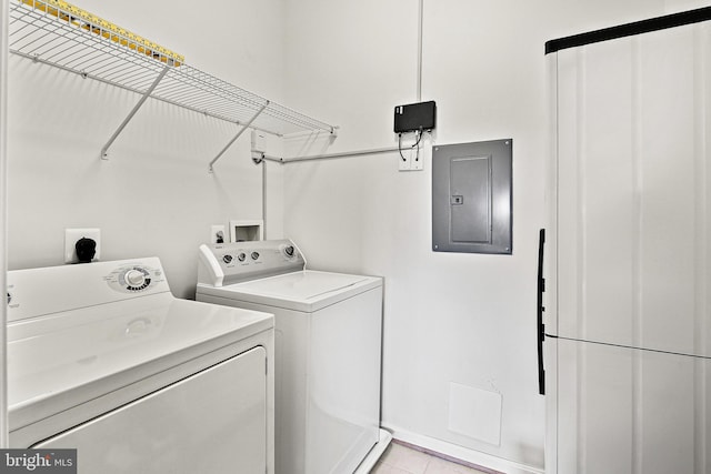 clothes washing area featuring light tile patterned floors, laundry area, electric panel, and separate washer and dryer