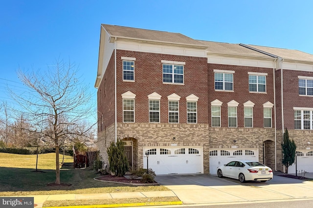 townhome / multi-family property featuring a garage, brick siding, driveway, and a front lawn